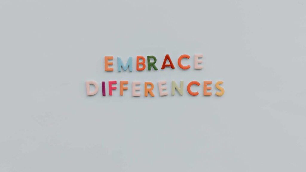 Colorful felt letters spell 'Embrace Differences' on a light gray surface, encouraging acceptance of an autism diagnosis