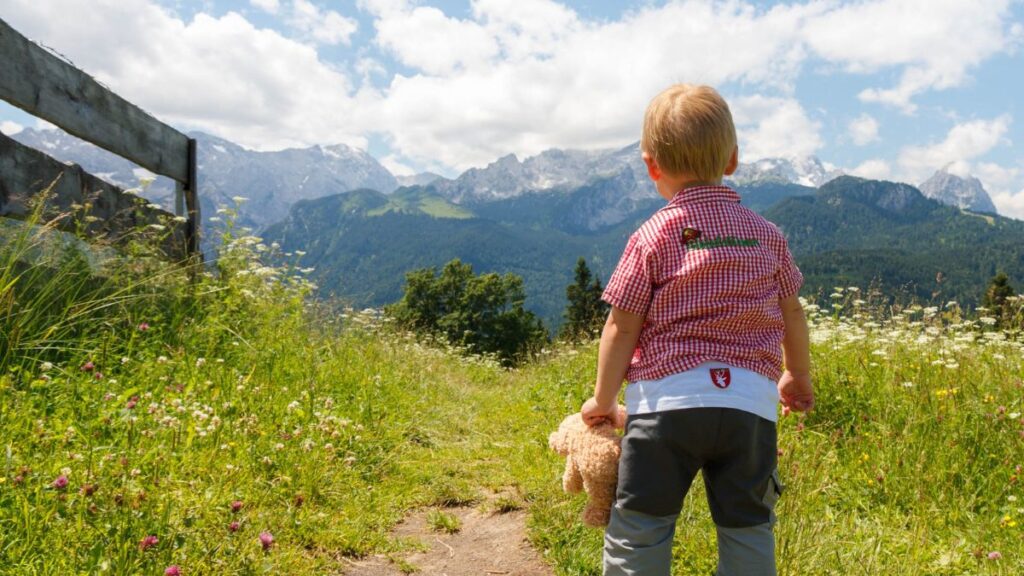Elopement in autism is depicted by a toddler walking on a diminished path towards mountains