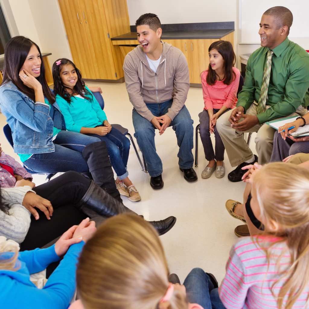 Group of people sitting in a circle during an autism support group meeting