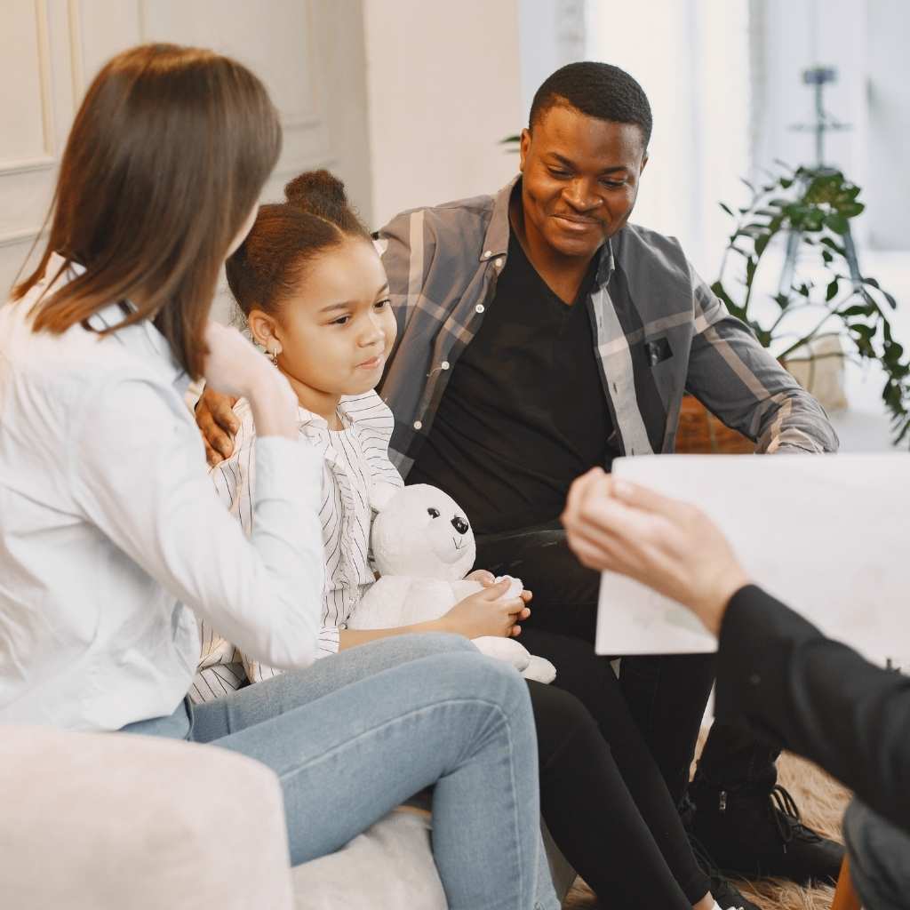 Child and parents in ABA session