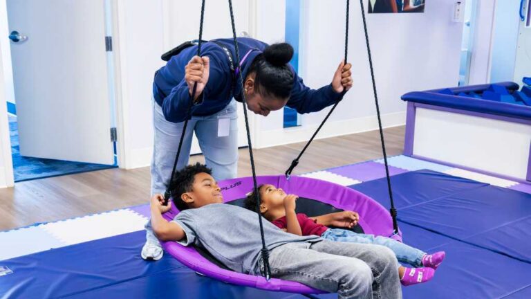 ABA therapy providers supporting children in a sensory gym