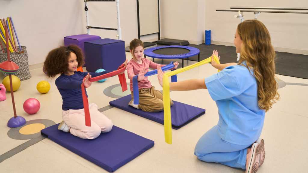 ABA therapy provider guiding children through a movement-based activity
