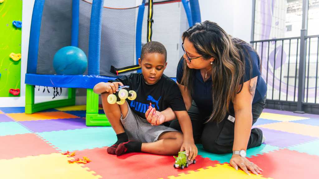 ABA therapist providing play-based therapy with child